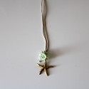 Small metal golden star with green flowers
