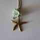 Small metal golden star with green flowers
